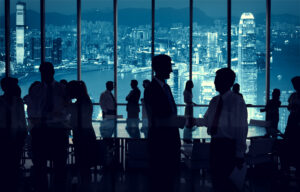 People discussing business in front of city skyline