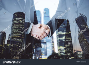 stock-photo-businesspeople-shaking-hand-on-abstract-skyscraper-background-teamwork-and-deal-concept-double-1663063432