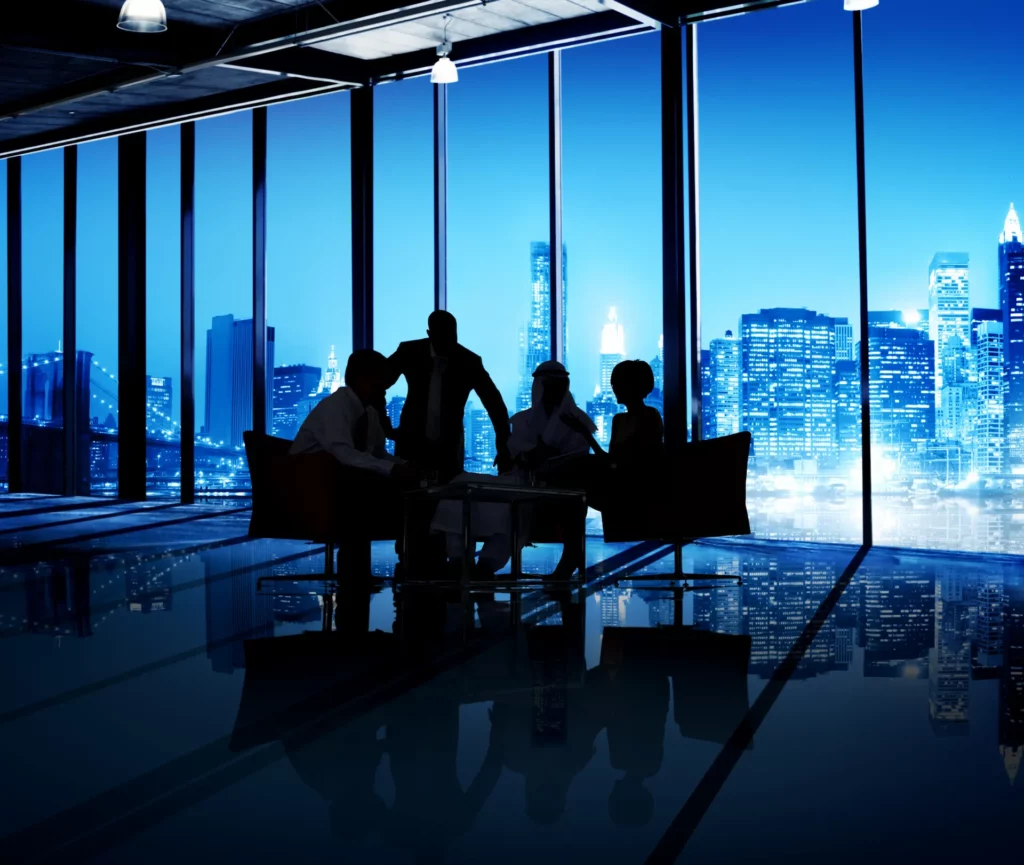 People seated at a table with a view of a city